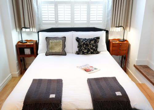 a bedroom with a large white bed with pillows at Rye Treat in Rye