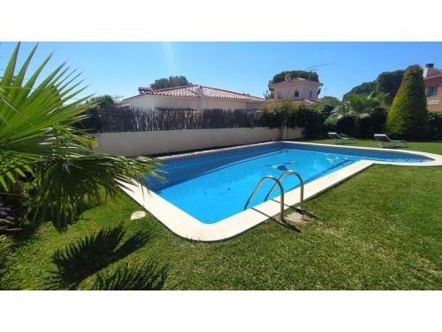 a swimming pool in the yard of a house at Villa Tropical in Comarruga