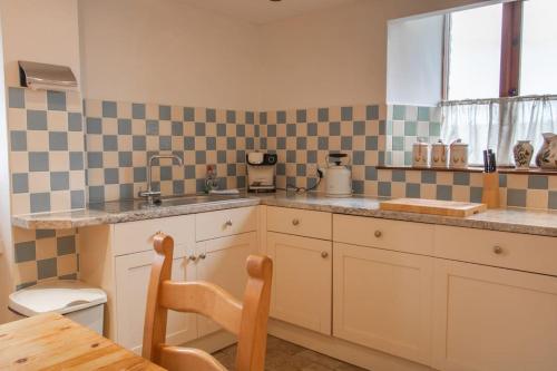 a kitchen with a sink and a counter top at The Wheelhouse at Hewish Mill in Bittadon