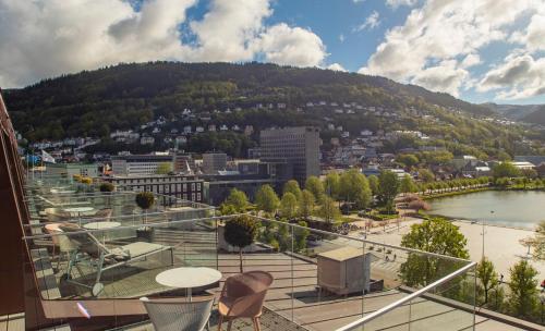 a balcony with a view of a city and a mountain at Hotel Norge by Scandic in Bergen