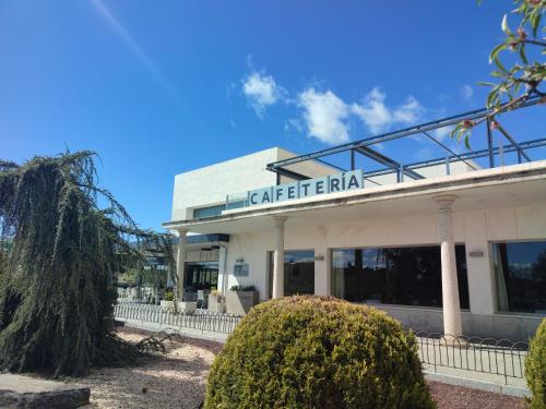 a building with a sign on top of it at Hotel Sercotel Cuatro Postes in Avila