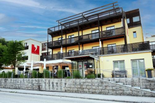 a building with balconies on the side of it at Apartmenthotel 's Mitterndorf in Traunkirchen