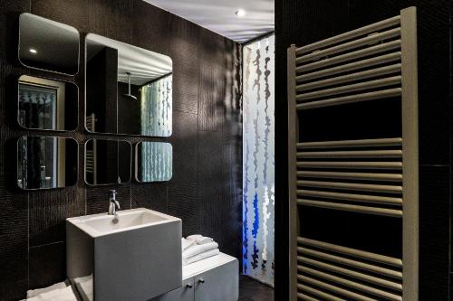 bagno con lavandino e specchio di A Point Porto Ercole Resort & Spa a Porto Ercole