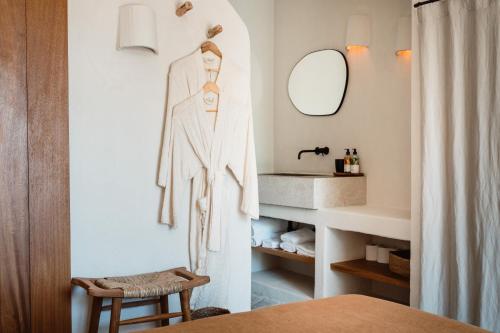 a bathroom with a robe hanging on a wall at Aguamadera in Santa Eularia des Riu