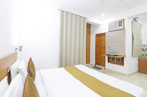 a hotel room with a bed and a bathroom at Hotel Trendy residency in New Delhi
