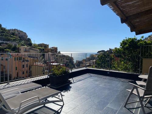 a balcony with chairs and a view of a city at Locanda Ca Da Iride in Riomaggiore