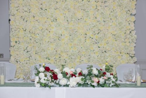 a table with two chairs and flowers on it at Park House Hotel in Shifnal