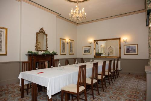 a conference room with a long table and chairs at Park House Hotel in Shifnal