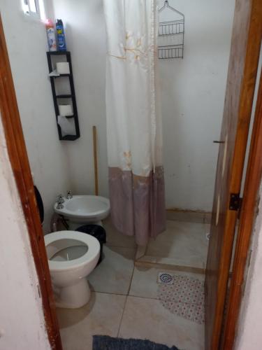 a small bathroom with a toilet and a sink at Doña Angela in Goya