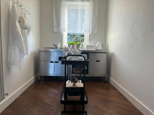 a small kitchen with a sink and a table at BG home in Radwanice