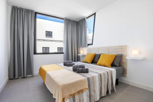 a bedroom with a bed and a large window at Las Cuestitas Sol in Pájara