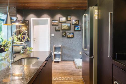 a kitchen with a sink and a refrigerator at Casa moderna e equipada em Petrópolis-RJ RSS175 in Petrópolis