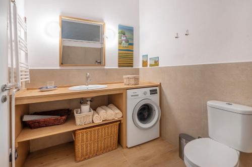a bathroom with a washing machine and a sink at Family Apt in Glyfada-Kyprou, by Comfortbnb in Athens