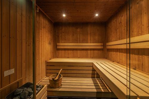 a sauna with wooden walls and wooden flooring at Tempus Hotel & Spa in Ponte da Barca