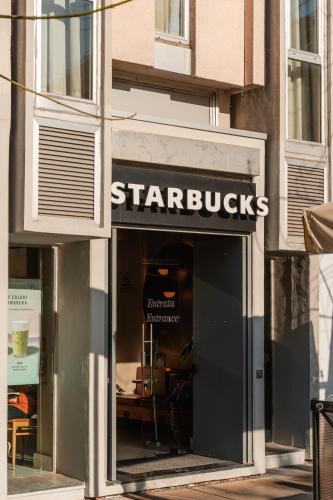 a starbucks sign on the front of a store at Twentyone Hotel in Rome