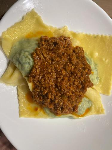 a white plate topped with food on top of pasta at Glamping Le Dune in Cinigiano