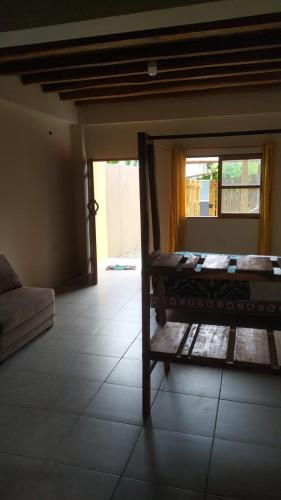 a room with a bunk bed and a couch at Hotel Palma Coco in Ayampe