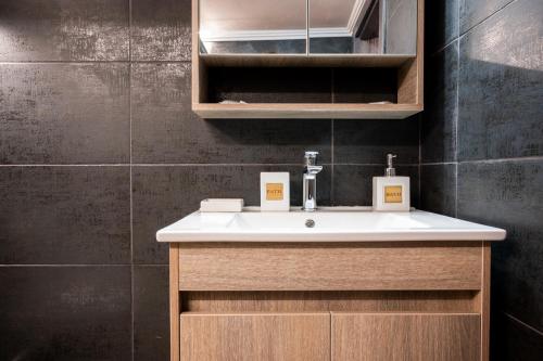 a bathroom with a white sink and a cabinet at eliTe deluxe 2 in Kavala