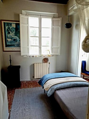 a bedroom with a bed and a window at Casa Natura Galicia in Santa María La Mayor del Rosario