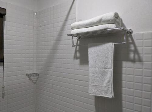 a bathroom with white towels on a towel rack at Cozy Studio room, Wi-Fi & Smart TV in Lagos