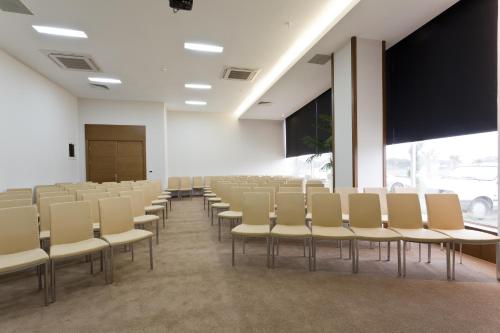 an empty room with chairs and a projection screen at Orucoglu Oreko Hotel in Manisa