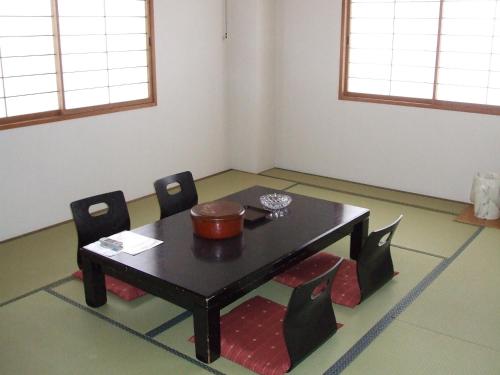 a room with a table and two chairs and a table at Hotel Yuzawa Yuzawa Denkiya in Yuzawa