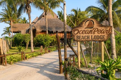 a beach lodge sign in front of a beach lodge at Ocean Pearl Beach Lodge in Vilanculos