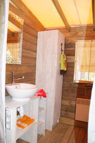 a bathroom with a sink and a shower at Camping Les Pêcheurs - Maeva in Roquebrune-sur-Argens