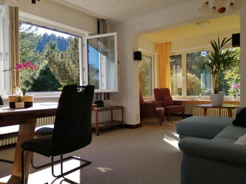 a living room with a table and a couch and a window at Home Relax 31 in Erbach im Odenwald