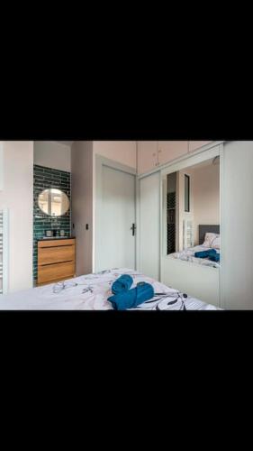 a bedroom with a blue teddy bear on a bed at Appartement totalement rénové 4 couchage proche Lyon in Oullins