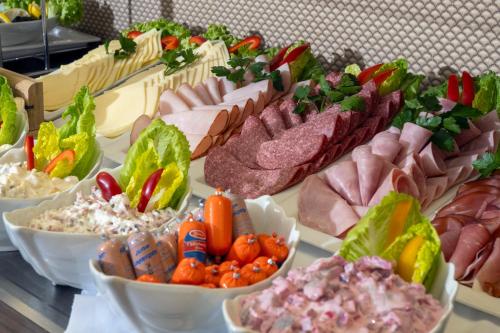 a table topped with lots of different types of food at Best Western Hotel am Spittelmarkt in Berlin