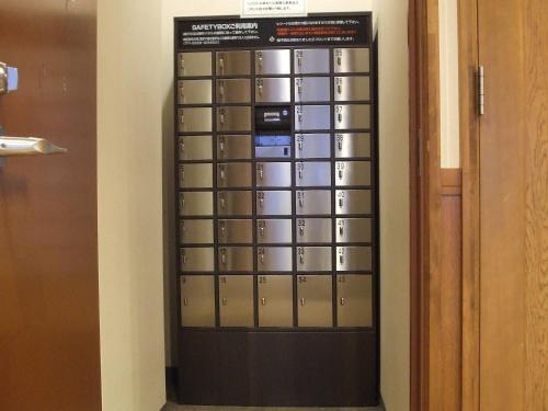 a room with a bunch of lockers in a wall at Hotel Yuzawa Yuzawa Denkiya in Yuzawa