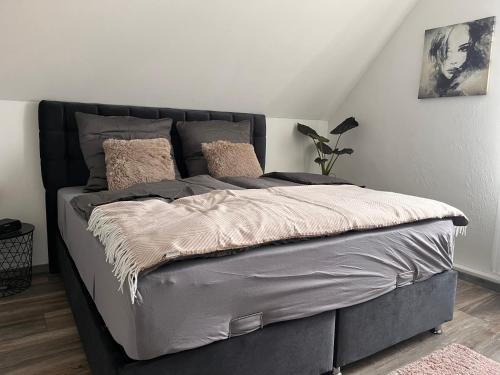 a bed in a bedroom with a gray bed frame at Apartment Am Stadtwald in Werne an der Lippe / NRW in Werne an der Lippe