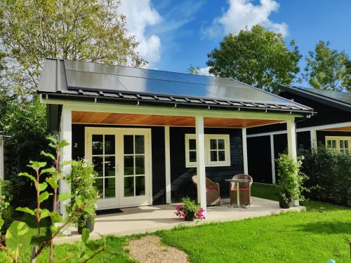 a house with a solar roof on top of it at Park De Driesprong in Nieuwveen