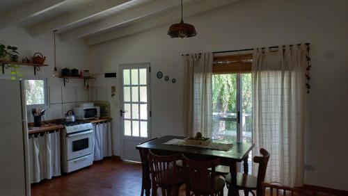a kitchen with a table and chairs in a room at La casita del Delta in Tigre