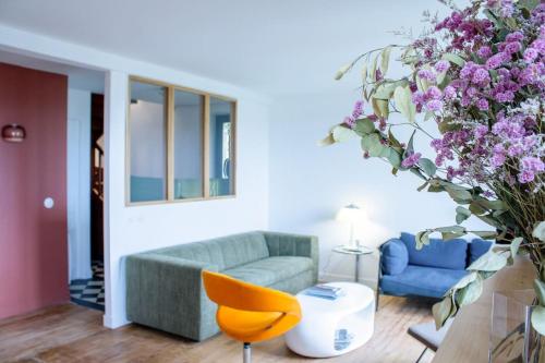 a living room with a couch and a chair at Ker Seasea/vue mer/wifi in Crozon