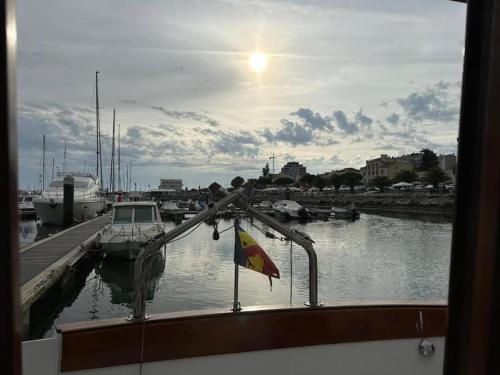 a boat is docked at a dock with a flag at Seadream Classic Yacht in Figueira da Foz
