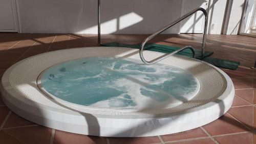 a jacuzzi bath tub with blue water in it at ALANDALUSTHALASSA.COM Apartamento con hermosas vistas in Vera