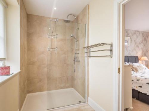 a shower with a glass door in a bathroom at 4 Bed in Ennerdale Bridge SZ308 in Cleator