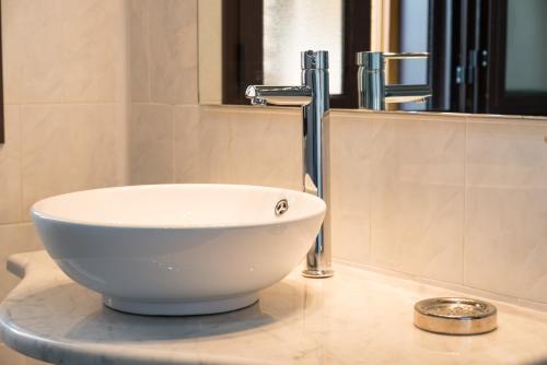 a white bowl sink on a counter in a bathroom at Hotel Villa Costes in Gallipoli