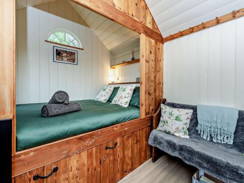 a bed in a tiny house with a bench at 1 Bed in Poynings 90450 in Poynings