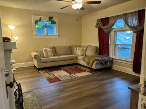 a living room with a couch and a window at Eclipse Quick Stay in Erie