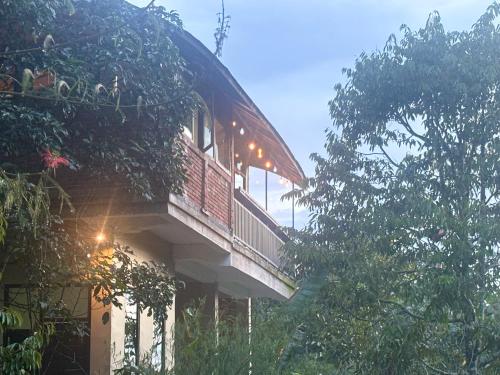 a building with a balcony with lights on it at Gumi Ayu EcoStay in Munduk