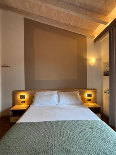 a bedroom with a large bed with two lamps at Locanda Ca Da Iride in Riomaggiore