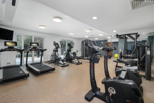 a gym with several treadmills and exercise bikes at Juvena Hotel Wellness & SPA Adults Only 12 plus in Międzywodzie