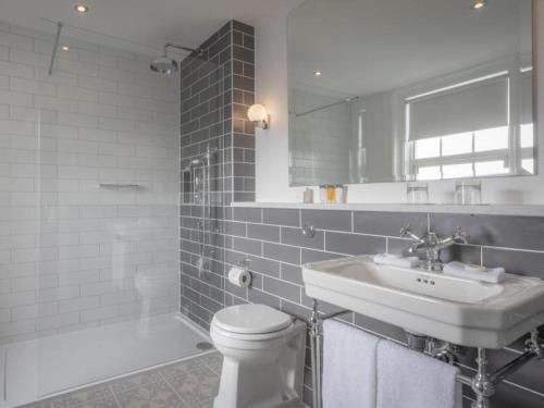 a white bathroom with a sink and a toilet at The Hardiman in Galway
