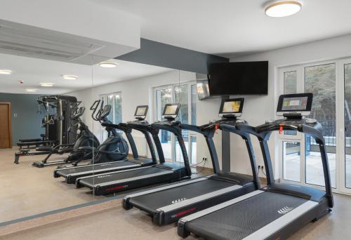 a gym with treadmills and elliptical machines at Juvena Hotel Wellness & SPA Adults Only 12 plus in Międzywodzie