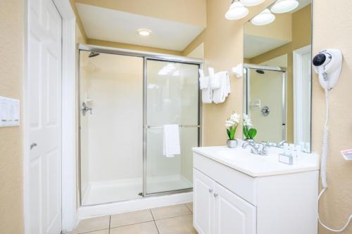 a bathroom with a shower and a sink at Beautiful Townhome, Vista Cay Resort Direct - 4010 in Orlando