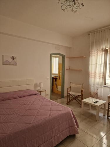 a bedroom with a bed and a table and a chair at Agriturismo Fuoco D'Amalfi Villa Iazzetta in Amalfi