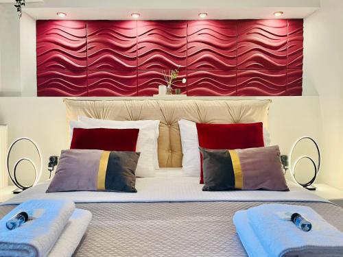 a bedroom with a large bed with a red wall at eliTe deluxe 2 in Kavala